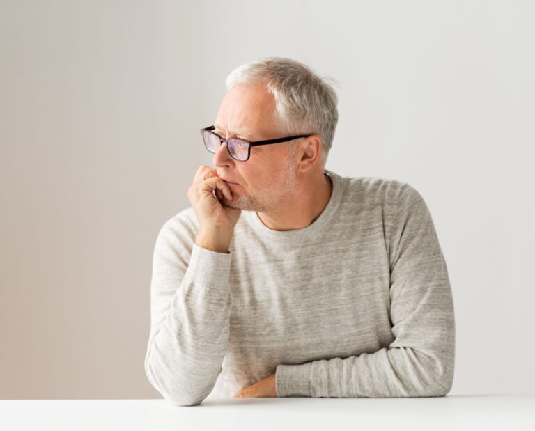 Homem preocupado com a próstata aumentada e o que pode ser a causa do problema