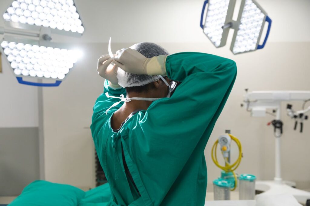 Cirurgião se coloca máscara para realizar prostatectomia